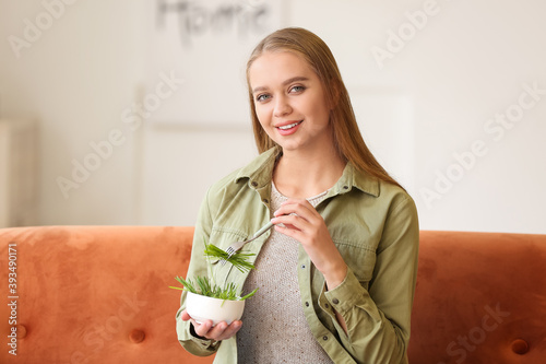 Young woman eating wheatgra...
