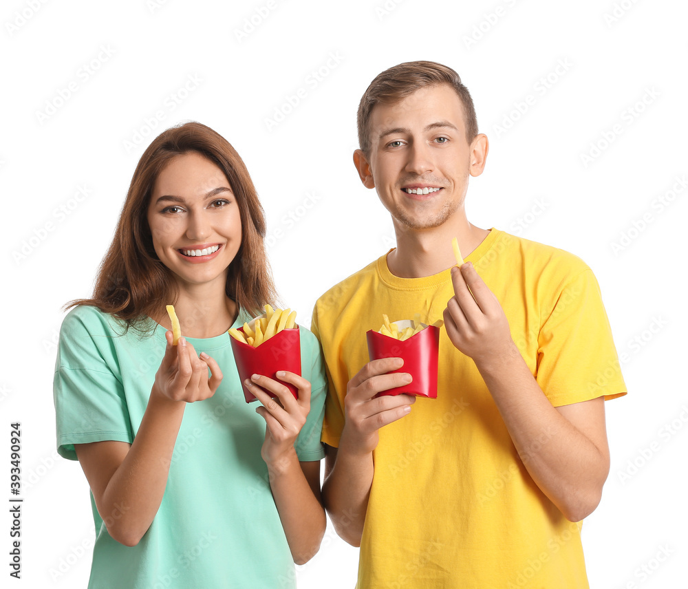 Young couple with french fries on white background Young couple with french fries on white background