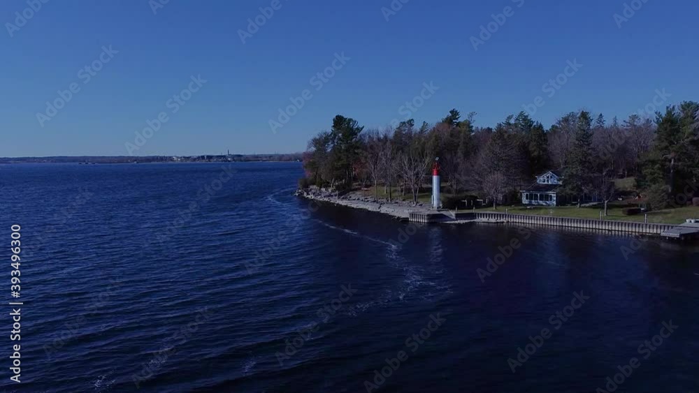 Aerial of a waterfront with a tiny lighthouse Aerial of a waterfront with a tiny lighthouse