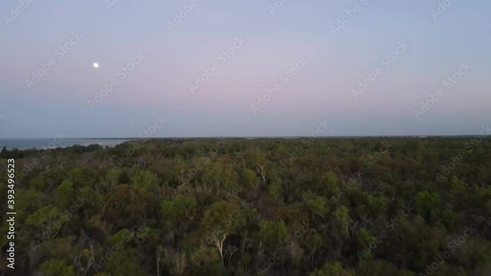 Low drone shot moving towards moon at Lee Point Darwin, Northern Territory Low drone shot moving towards moon at Lee Point Darwin, Northern Territory