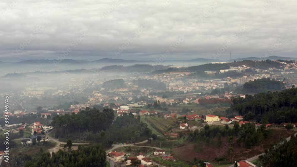 Aerial view of a big city in the countryside of Portugal covered by fog. Aerial view of a big city in the countryside of Portugal covered by fog.