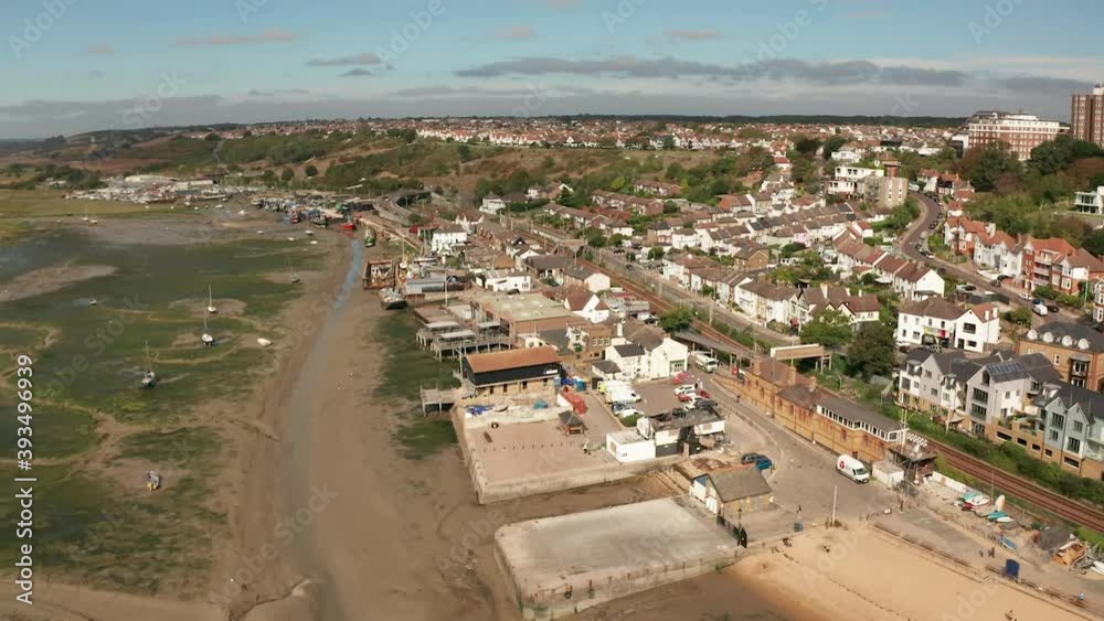 Flying backwards and pivoting to reveal sandy beach and houses over coastal fishing village over marshes. Aerial shot Mavic 2 pro. HD 50fps Flying backwards and pivoting to reveal sandy beach and houses over coastal fishing village over marshes. Aerial shot Mavic 2 pro. HD 50fps