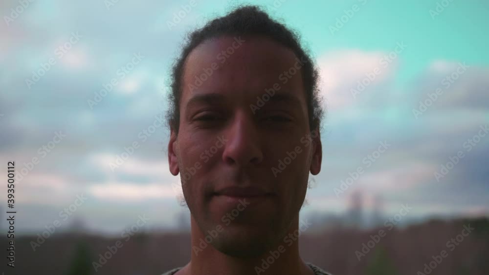Calm and handsome black adult man opens eyes and smiles, slow motion Calm and handsome black adult man opens eyes and smiles, slow motion
