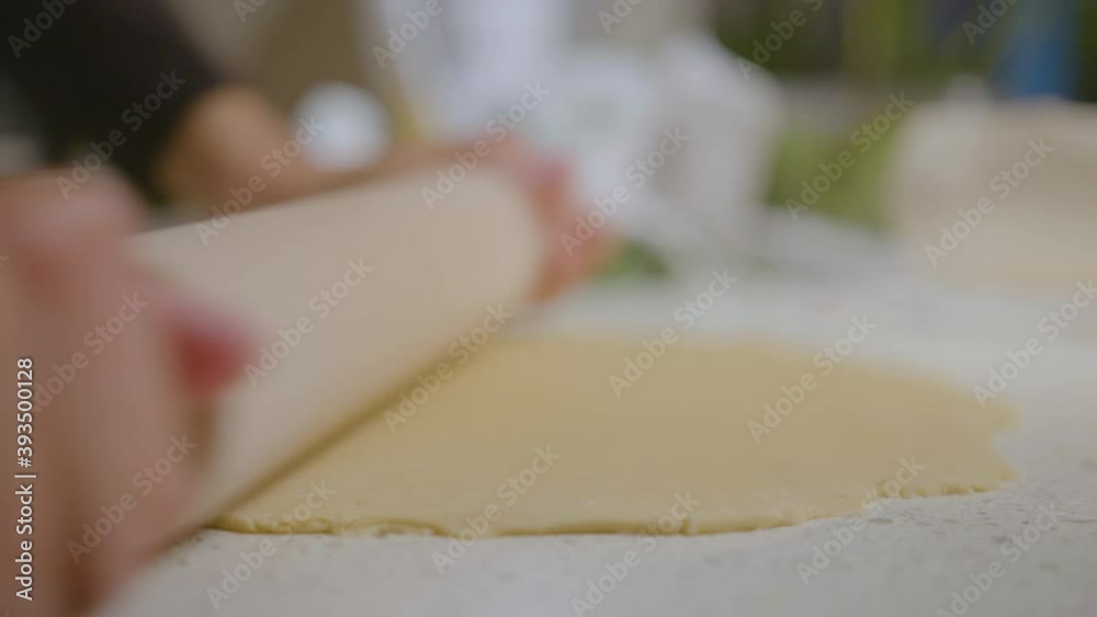 Woman rolling out pizza dough. Close up. Slow Motion. Woman rolling out pizza dough. Close up. Slow Motion.