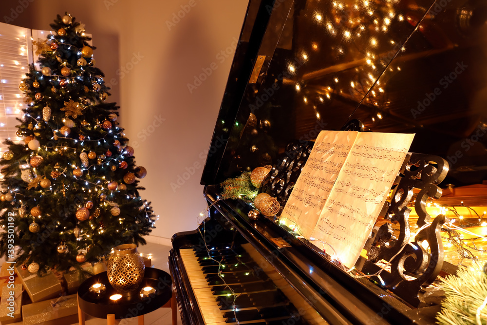 Grand piano decorated for Christmas in room