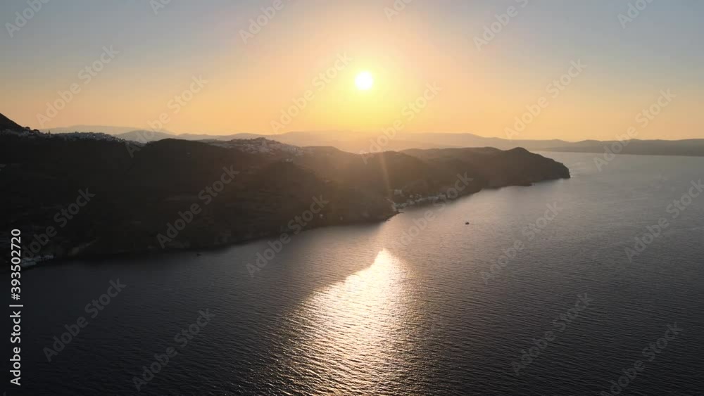 Aerial jib up shot of Milos island coastline and revealing Plaka town just after sunrise Aerial jib up shot of Milos island coastline and revealing Plaka town just after sunrise