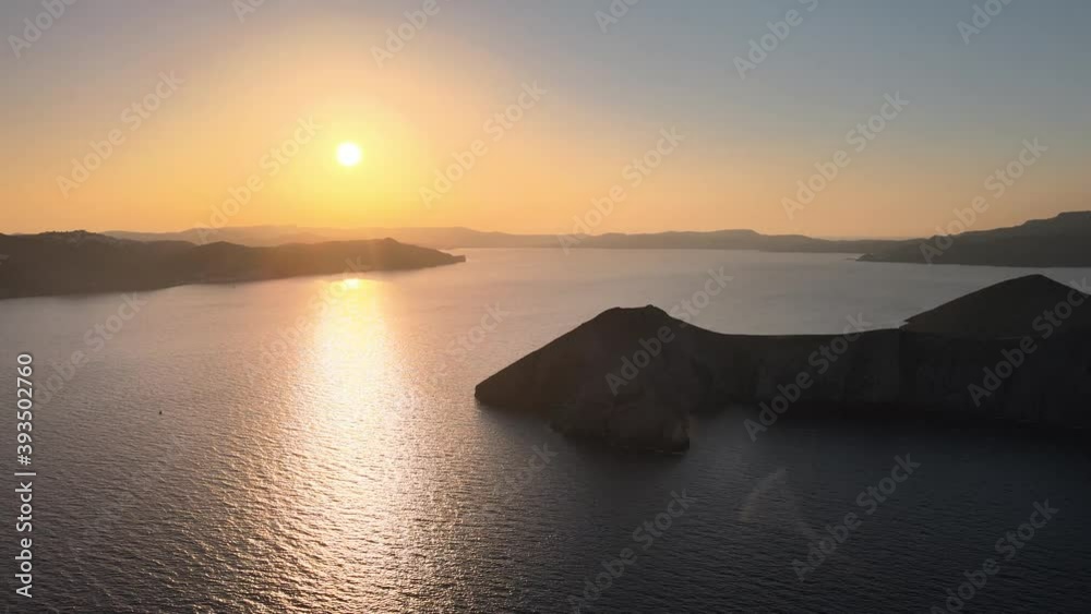 Aerial dolly right shot of a beautiful sunrise over Milos island coastline, Greece Aerial dolly right shot of a beautiful sunrise over Milos island coastline, Greece