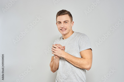 handsome man in light t-shirt cropped view emotion studio isolated background