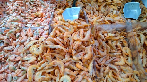 Frozen king prawns in the supermarket. Fish department. Delicious shrimps. Seafood products for home cooking. Groceries store. Retail industry. Ingredients background. Expensive food for sale. Market.