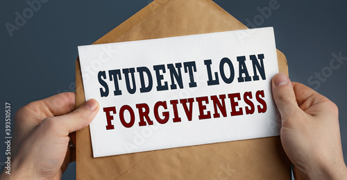 Wallpaper Mural Male hands holding craft envelope with text STUDENT LOAN FORGIVENESS on blue background Torontodigital.ca
