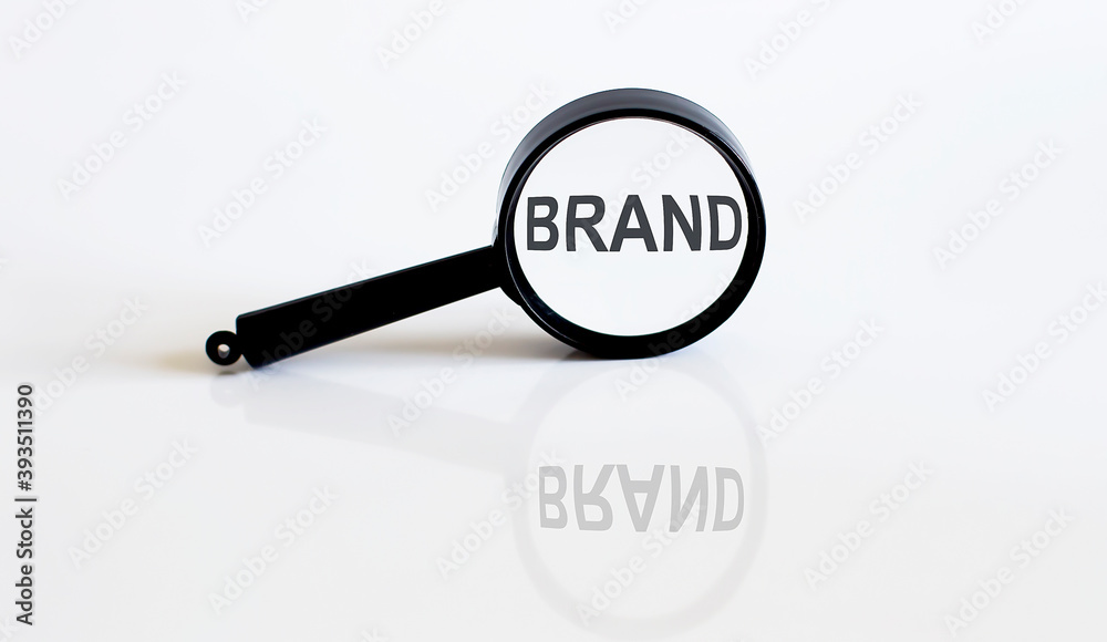 Magnifier with text BRAND on the white background Magnifier with text BRAND on the white background
