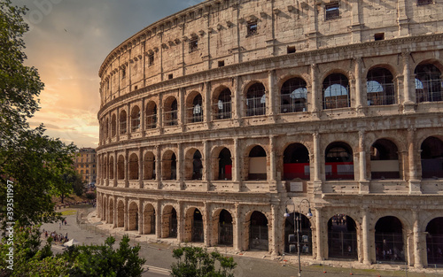 Colosseum ancient arena during sunrise with impressive sky, Rome Italy