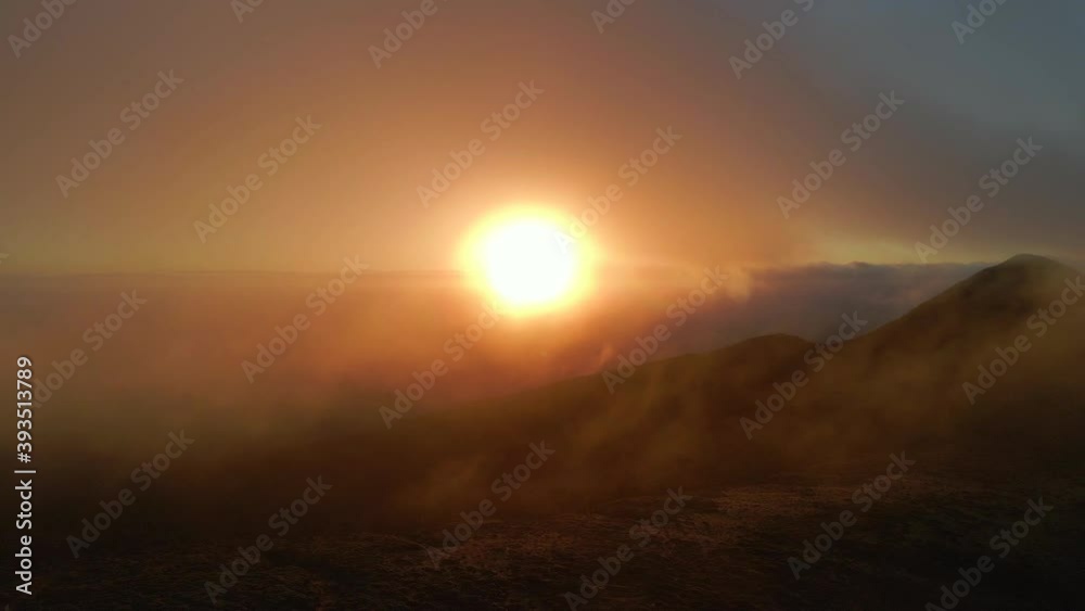 Silhouette of mountain range during misty sky with golden sunrise in background early in the morning - New Zealand Silhouette of mountain range during misty sky with golden sunrise in background early in the morning - New Zealand