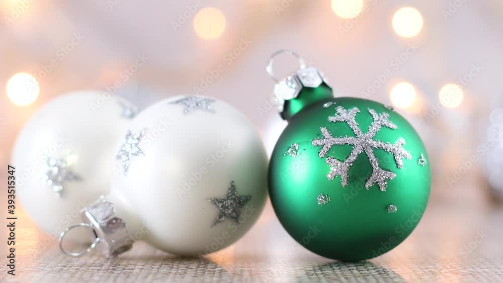 White and green Christmas ornament with snowflake and blinking lights behind White and green Christmas ornament with snowflake and blinking lights behind