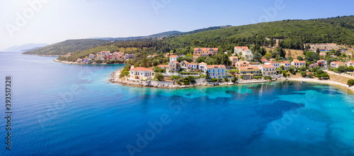 Fototapeta Naklejka Na Ścianę i Meble -  Panoramic aerial view to the beautiful village of Fiskardo on the island of Kefalonia, Greece, with colorful, red roofed houses by the turquoise sea