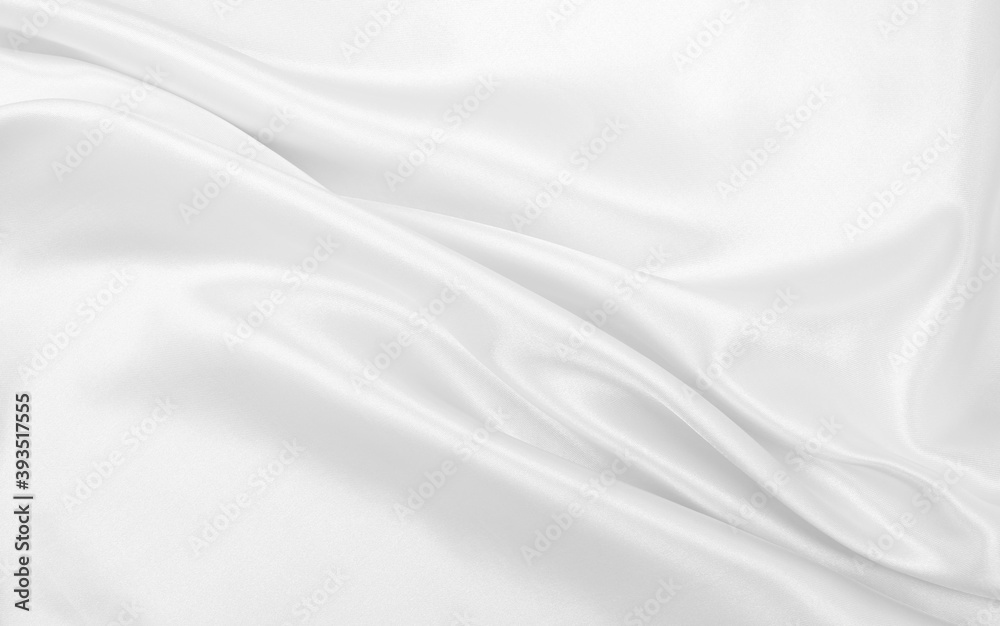 Smooth elegant white silk or satin luxury cloth texture  as wedding background. Luxurious background design