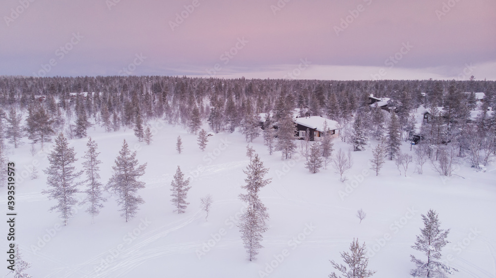Visit Lapland Holidays. Aerial drone panorama shot of the forest covered in snow winter and the village inside the Arctic Circle. Lapland, Finland. Winter sunrise. Igloos and cabins covered with snow Visit Lapland Holidays. Aerial drone panorama shot of the forest covered in snow winter and the village inside the Arctic Circle. Lapland, Finland. Winter sunrise. Igloos and cabins covered with snow