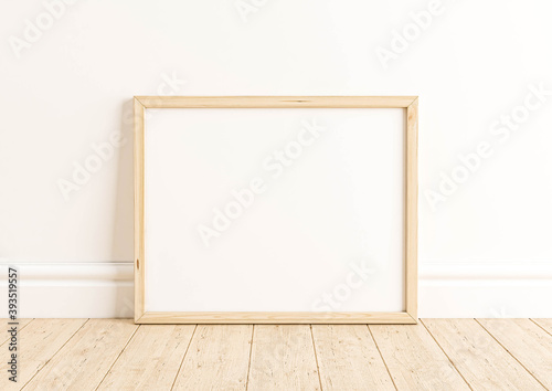 Horizontal 8x10 Wood Frame Mockup. Horizontal Wood Frame on a wooden floor and white wall.
