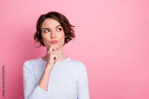 Focused smart girl look copyspace touch hand chin think decide wear pullover isolated pastel color background photo