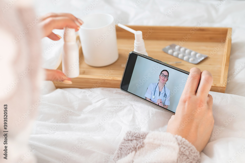 The doctor gives an online consultation to the patient. The woman in quarantine communicates with the attending physician The doctor gives an online consultation to the patient. The woman in quarantine communicates with the attending physician