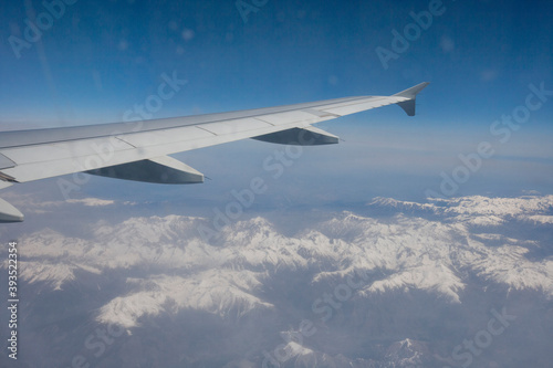 Aerial view of snow covered alps through airplane; France