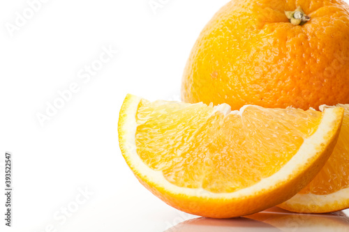 Closeup of a sliced orange fruit on white background.