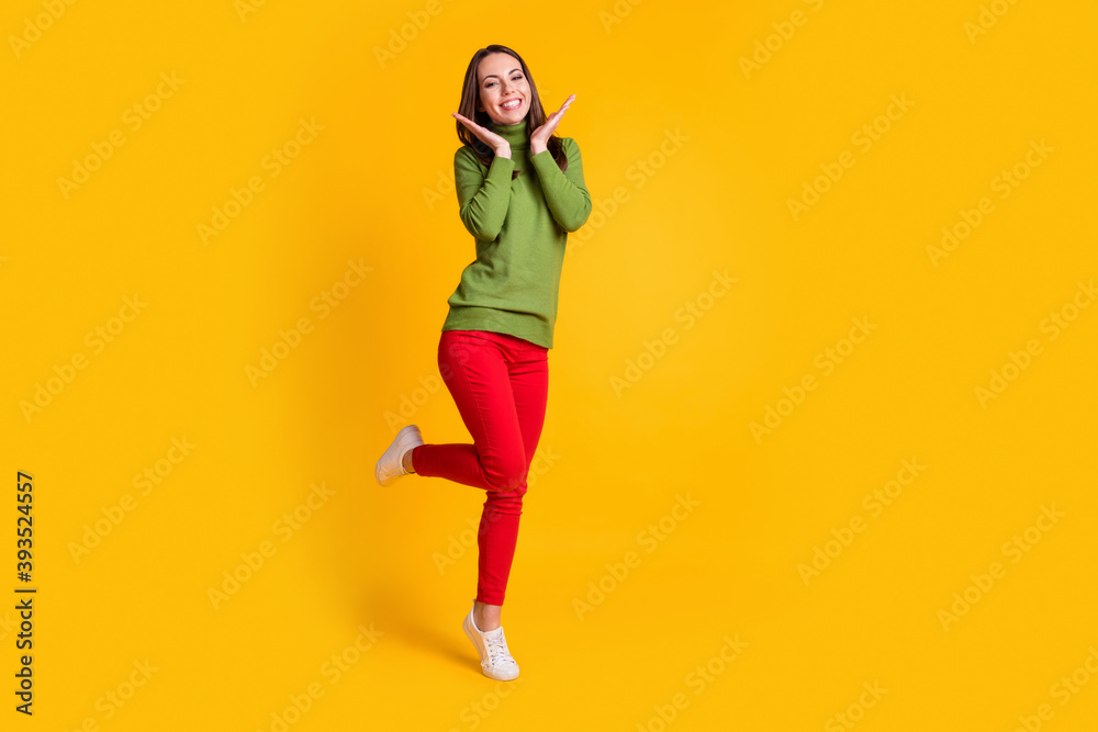 Full length body size view o pretty delighted cheerful thin girl jumping having fun isolated on bright yellow color background