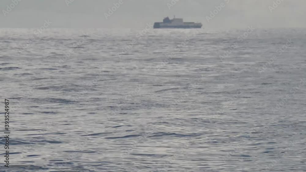 ferry ship on the horizon on calm autumn sea ferry ship on the horizon on calm autumn sea