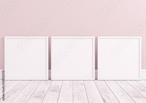 Three square white frame mockups for nursery or kids room. Children room nursery mockup frame poster on clean pink wall and white wood floor.