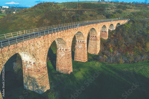 Old Arched Stone Railroad Viaduct Bridge. Plebanivka, Ternopil Oblast, Ukraine, Europe. View from above photo