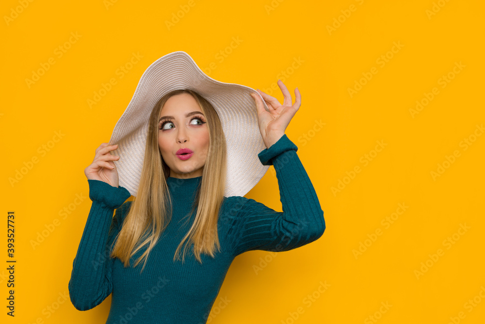 Surprised Beautiful Young Woman In White Sun Hat And Teal Sweater Is Looking Away Surprised Beautiful Young Woman In White Sun Hat And Teal Sweater Is Looking Away