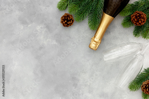 New Year decoration with champagne bottle and fir branches on Gray marble background