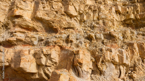 Stony slope of a sheer cliff. Textured background.