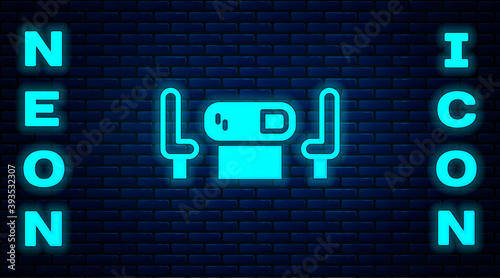 Glowing neon Poker table icon isolated on brick wall background. Vector.