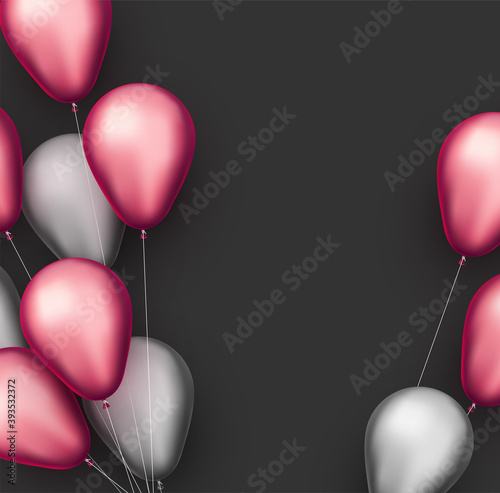 Silver and pink foil balloons with threads on black background.