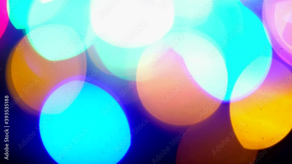 Blur of Christmas wallpaper decorations concept xmas. Holiday festival backdrop. Abstract blurred of colored glittering shine bulbs lights on black background. Dolly shot Blur of Christmas wallpaper decorations concept xmas. Holiday festival backdrop. Abstract blurred of colored glittering shine bulbs lights on black background. Dolly shot