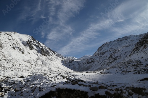 Snowy mountains covered in clouds beautified by the sky