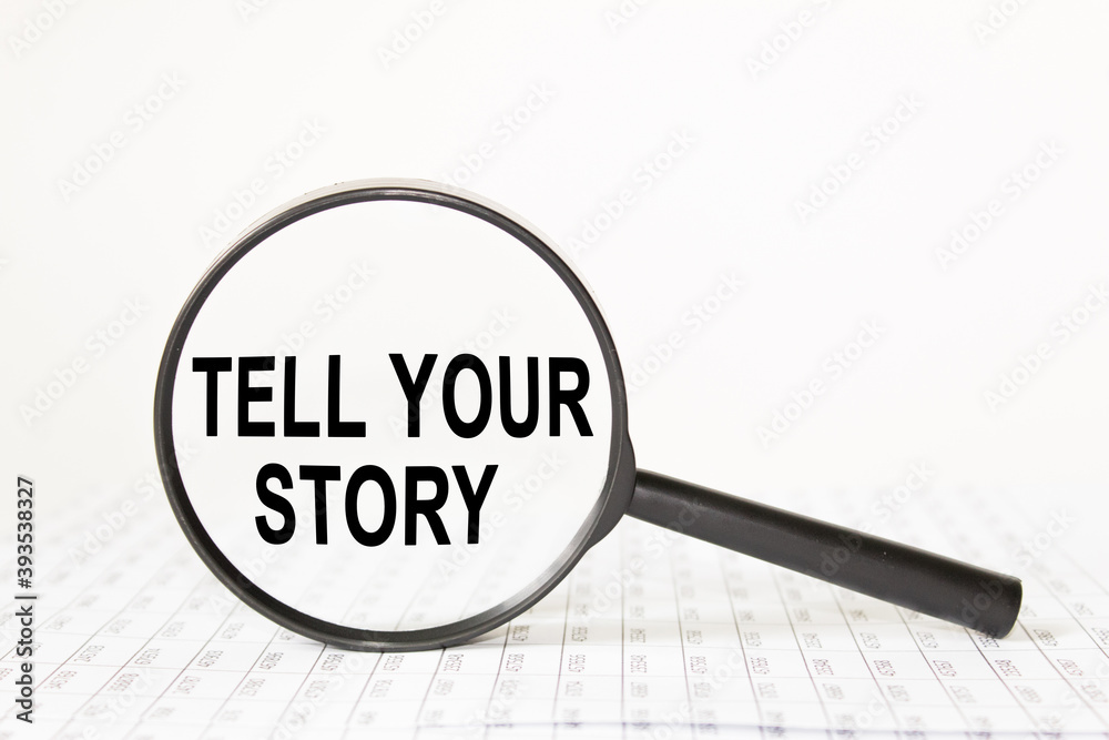 a sheet on a black background with text TELL YOUR STORY. business concept