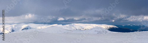 A panorama of a snow-covered mountain range. Panorama from multiple shots. © Oleksiy