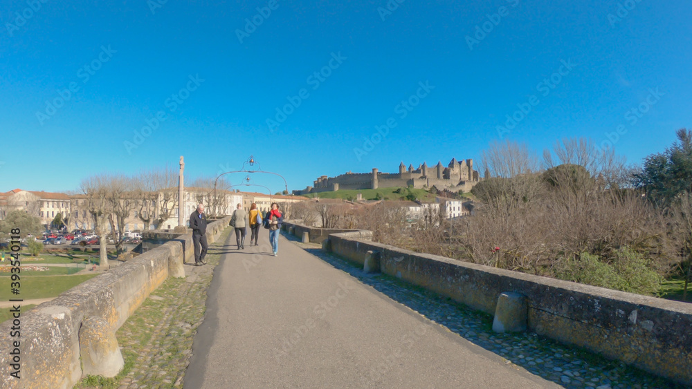 Carcassonne / France - March 11, 2020 - The Old Bridge (Pont Vieux, 14th Cent) leading to Medieval town of Carcassonne (Cité), Languedoc-Roussillon.