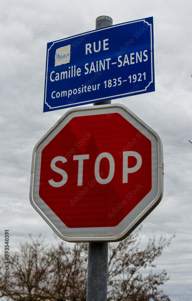 Carcassonne / France - March 15, 2020: French traffic sign, STOP sign and  Carcassonne street sign Rue Camille Saint-Saens Street. Stock Photo