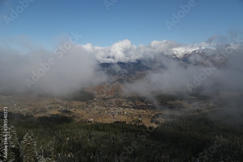 Snowy mountains covered in clouds beautified by the sky