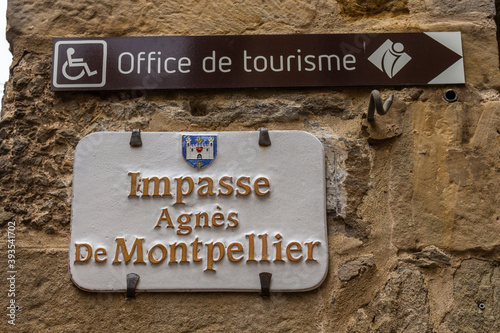 Carcassonne / France - March 15, 2020: Carcassonne Cité street sign Impasse Agnes de Montpellier Street and Tourism Office direction sign.
