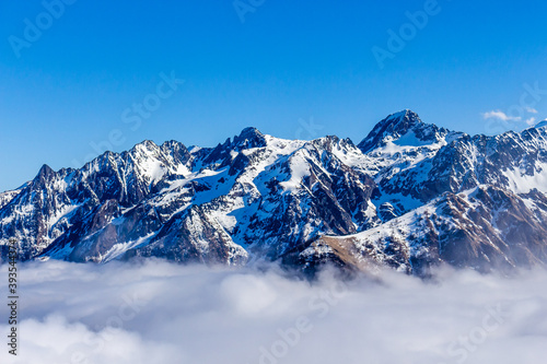 Fototapeta Naklejka Na Ścianę i Meble -  Snow and mountain peaks in the french Pyrenees near the Luchon Superbagnères Ski Resort in the Arrondissement of Saint-Gaudens, Occitania, Haute-Garonne, France. The Luchonnais Mountains aerial view.