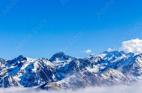 Snow and mountain peaks in the french Pyrenees near the Luchon Superbagnères Ski Resort in the Arrondissement of Saint-Gaudens, Occitania, Haute-Garonne, France. The Luchonnais Mountains aerial view. © An Instant of Time