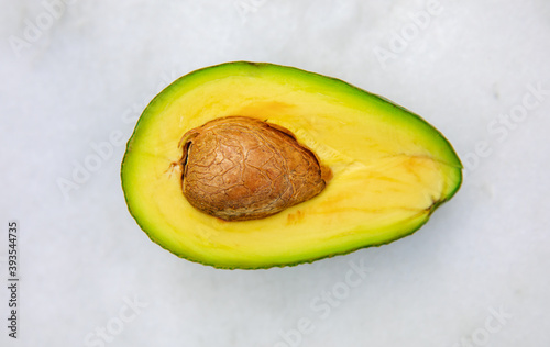 Fresh, organic, healthy and ripe avocado fruit cut in half on isolated white background