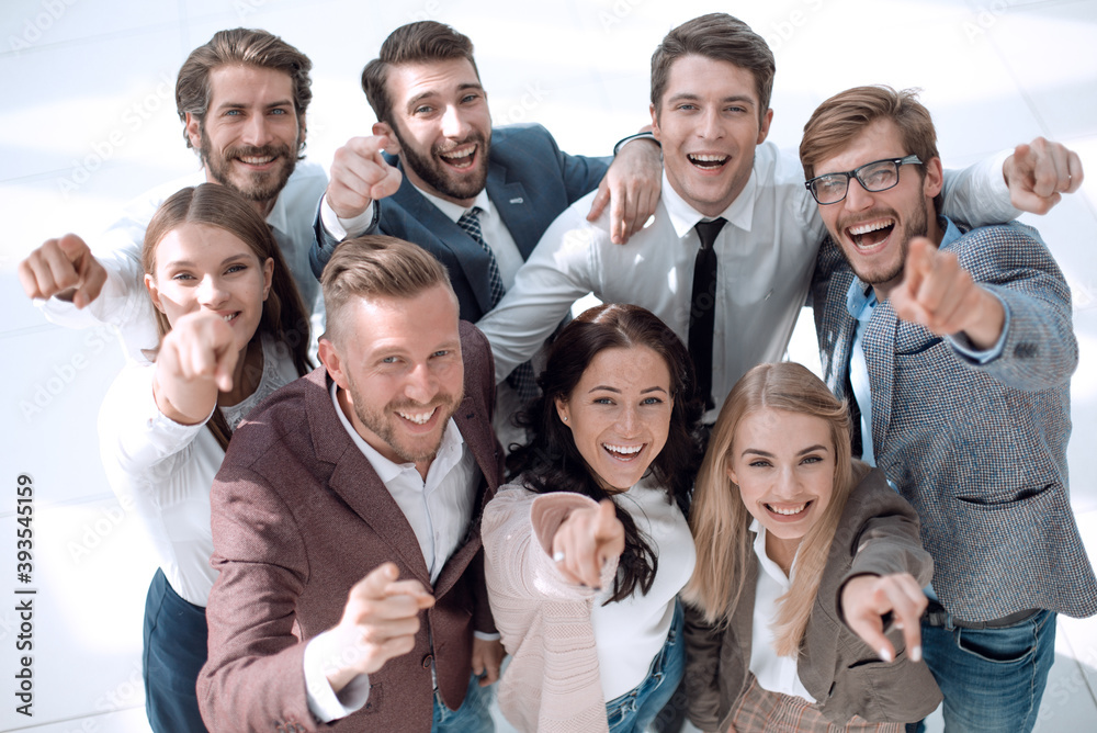 happy team of successful young business people pointing at you happy team of successful young business people pointing at you