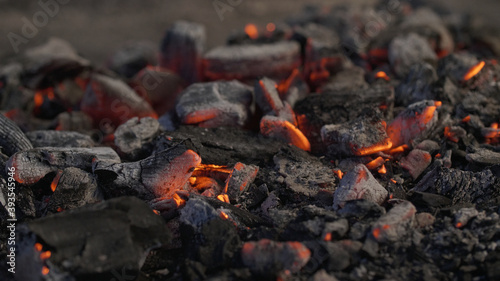 Burning charcoal on a barbecue. Glowing ashes with embers.