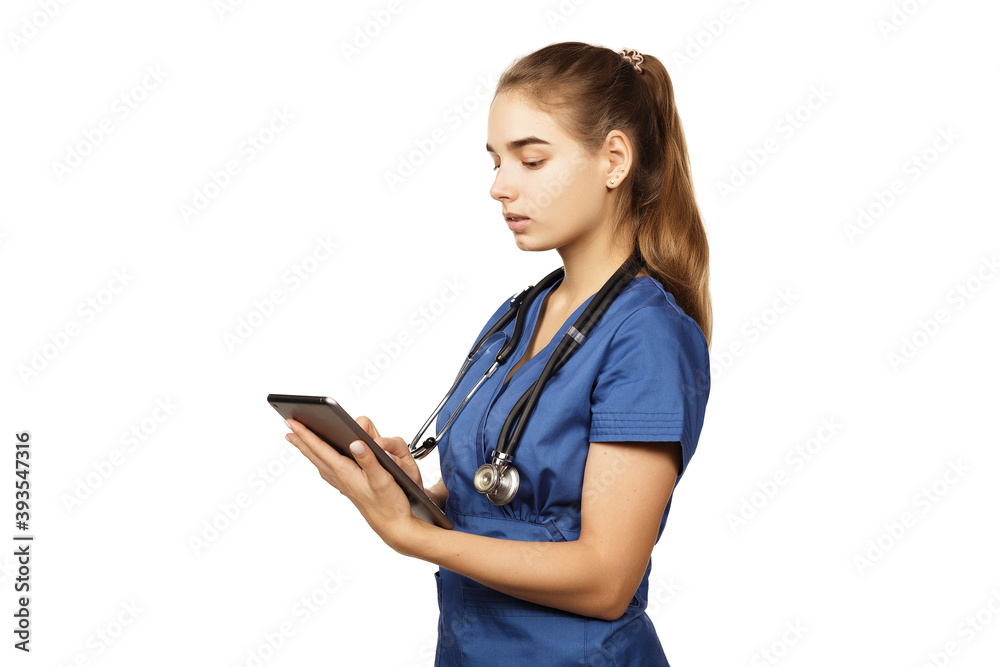 Healthcare, technology and medicine concept - female doctor in blue surgical suit with stethoscope and tablet computer. Healthcare, technology and medicine concept - female doctor in blue surgical suit with stethoscope and tablet computer.