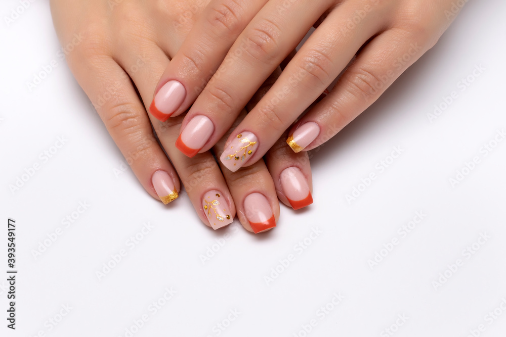 Autumn orange French manicure with golden tree and crystals on long square nails on a white background close up Autumn orange French manicure with golden tree and crystals on long square nails on a white background close up